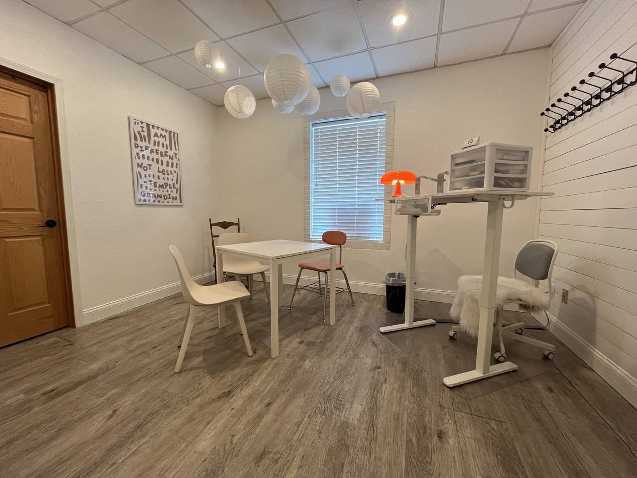 Photo showing Julia's desk on the right with a table and chairs in the center that can be utilized for parent meetings.